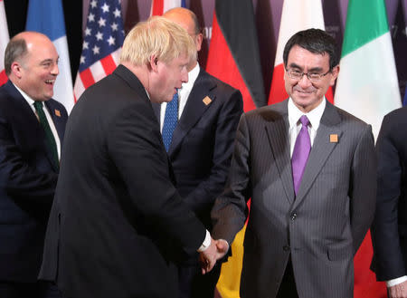 Britain's Foreign Secretary Boris Johnson and Japan's Minister of Foreign Affairs Taro Kono wait for a group photo to take place on the second day of meetings for foreign ministers from G7 countries in Toronto, Ontario, Canada April 23, 2018. REUTERS/Fred Thornhill