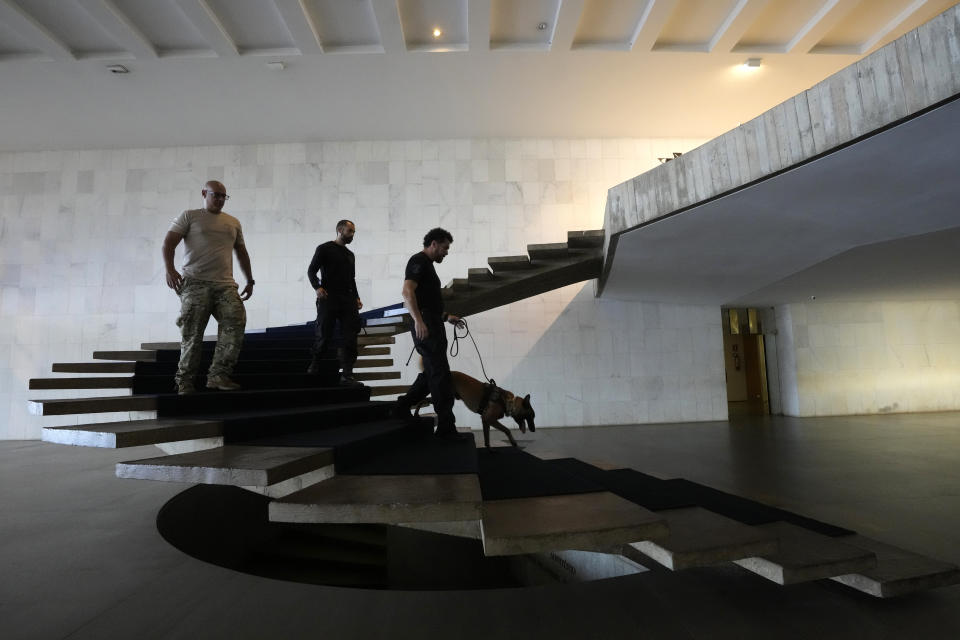 Federal Police use a bomb detection dog to inspect Itamaraty Palace to prepare for the arrival of Russia's Foreign Minister Sergey Lavrov in Brasilia, Brazil, Monday, April 17, 2023. Lavrov will meet with Brazil's Foreign Minister. (AP Photo/Eraldo Peres)