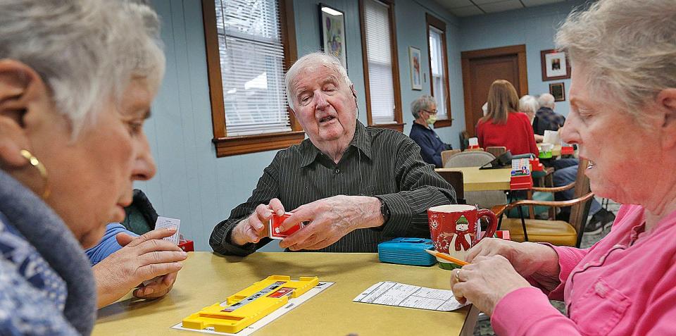 Bob Boyd, center,  who is blind, plays bridge at the Puritan Bridge Club in Braintree on Tuesday, Jan. 31, 2023. At left is his partner, Pat Di Sciullo, left, of Easton, and Mimi Roos, right, of Milton.