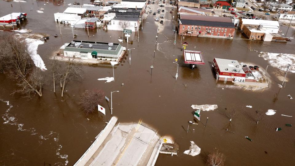 The swollen Pecatonica River spills into downtown Darlington, Wis., on Thursday March 14, 2019.  The National Weather Service has issued a flood warning or flood watch for about two-thirds of the state.