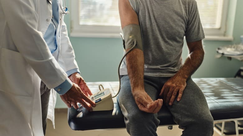 man getting blood pressure taken