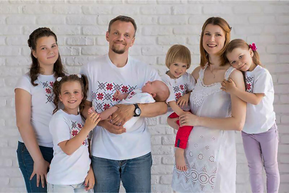 This undated handout photo released by Human Rights Center "Viasna" spring96.org on Friday, Dec. 3, 2021, shows Belarussian activist Volha Zalatar, second right, with her husband Sergei Gankevich and their children, Minsk, Belarus. A Belarus court has on Friday sentenced Volha Zalatar to four years in prison for creating an "extremist group" on the messaging app Telegram, the country's top rights group, Viasna, reported. Zalatar, a 38-year old mother of five underaged children, has been held in custody since March. (Human Rights Center "Viasna" spring96.org via AP)