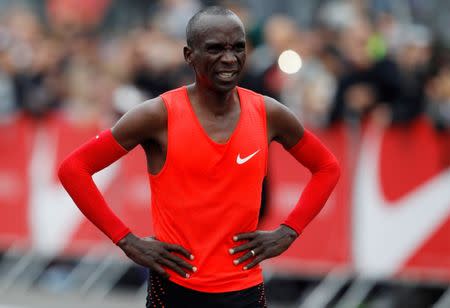 Kenyan Eliud Kipchoge reacts after crossing the finish line during an attempt to break the two-hour marathon barrier at the Monza circuit in Italy, May 6, 2017. REUTERS/Alessandro Garofalo