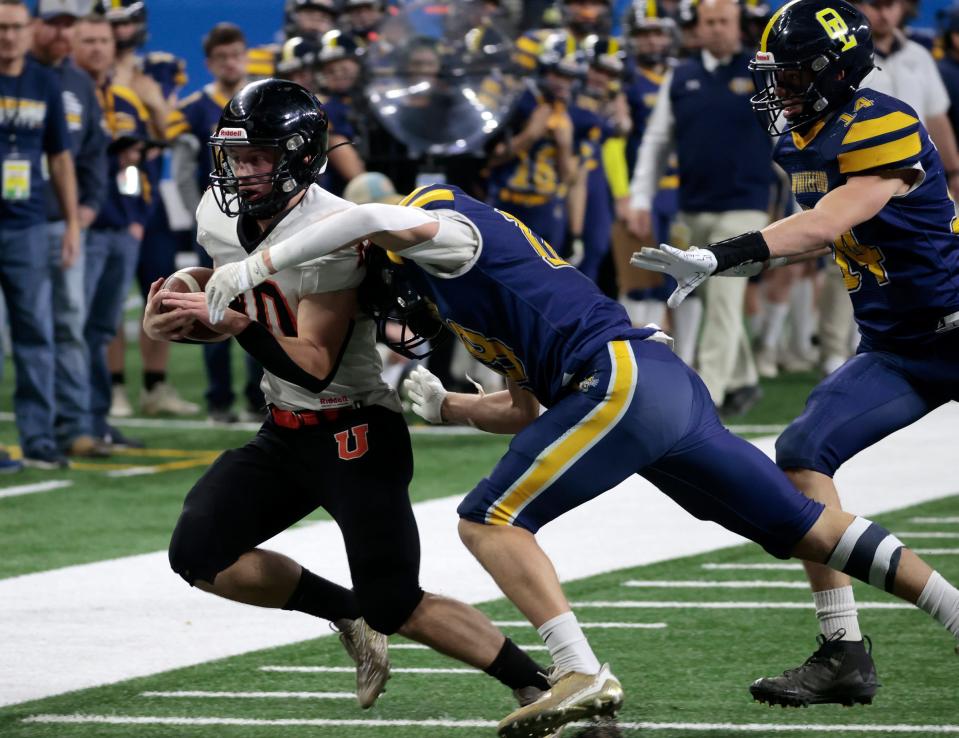 Ubly's Evan Peruski gets pushed out of bounds near the end zone by Ottawa Lake Whiteford's Kolby Masserant during the first half of the Division 8 football state championship game on Saturday, Nov. 25, 2023, at Ford Field.
