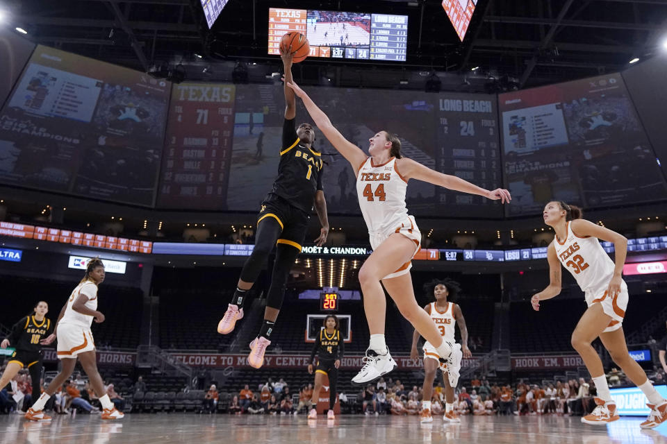 Long Beach State guard Lovely Sonnier (1) drives to the basket against Texas forward Taylor Jones (44) during the second half of an NCAA college basketball game in Austin, Texas, Wednesday, Dec. 6, 2023. (AP Photo/Eric Gay)