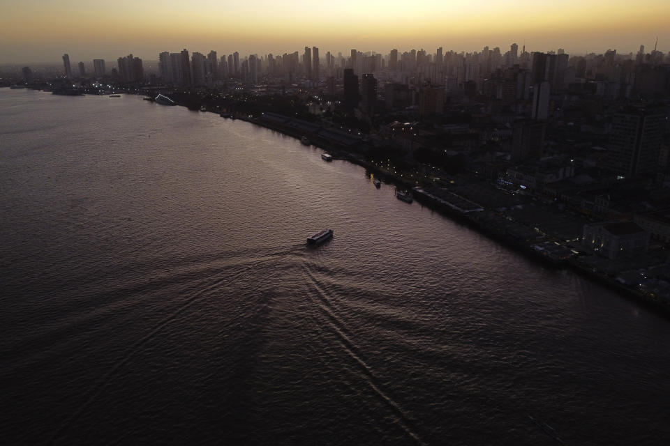 FILE - The sun rises over the bay of the Guama River in Belem, Brazil, Aug. 7, 2023. The two-day Amazon Summit opens Tuesday, Aug. 8, 2023, in Belem, where Brazil hosts policymakers and others to discuss how to tackle the immense challenges of protecting the Amazon and stemming the worst of climate change. (AP Photo/Eraldo Peres)