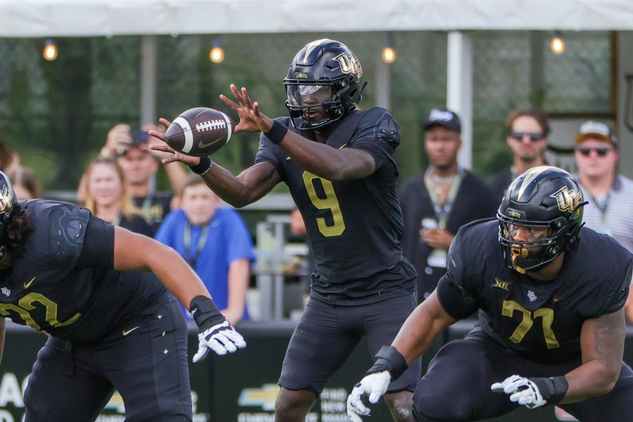 UCF Knights quarterback Timmy McClain (9) receives the snap during the first quarter against the Baylor Bears on Sept. 30, 2023, at FBC Mortgage Stadium in Orlando, Florida.