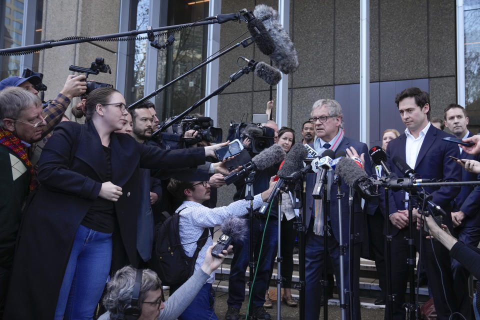 Australian journalist Chris Masters gestures as he and Nick McKenzie address the media outside the Federal Court in Sydney, Australia, Thursday, June 1, 2023. Australia’s most decorated living war veteran unlawfully killed prisoners and committed other war crimes in Afghanistan, a judge ruled Thursday in dismissing the claims by Victoria Cross recipient Ben Roberts-Smith that he was defamed by media. (AP Photo/Mark Baker)