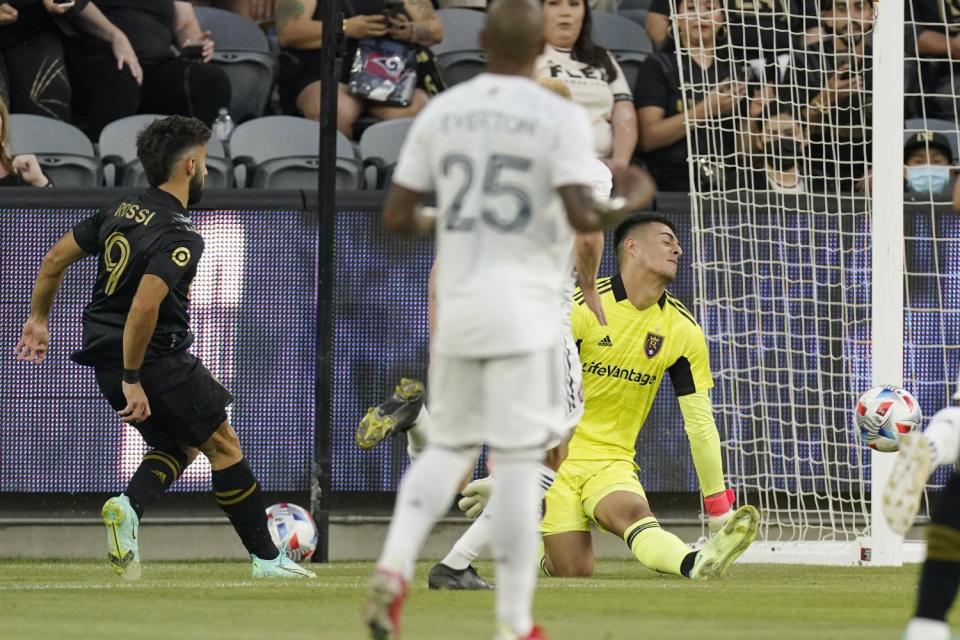 LAFC's Diego Rossi, left, scores on Real Salt Lake goalie David Ochoa, right, as midfielder Everton Luiz looks on.