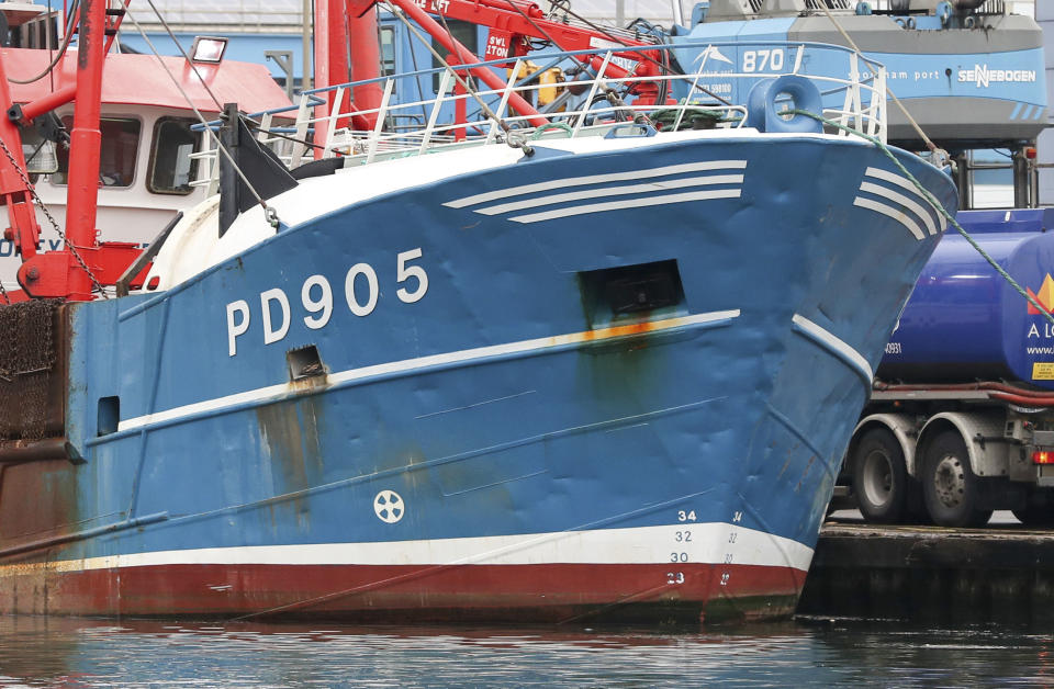 The bow of the Honeybourne 3, a Scottish scallop dredger, in dock at Shoreham, south England, Wednesday Aug. 29, 2018, following clashes with French fishermen in the early hours of Tuesday morning off France's northern coast. French maritime authorities are appealing for calm after fishermen from rival French and British fleets banged their boats in ill-tempered skirmishes over access to the scallop-rich waters off France's northern coast. (Andrew Matthews/PA via AP)