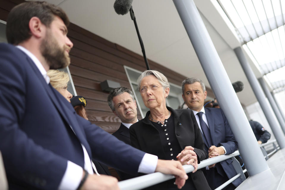 French Prime Minister Elisabeth Borne, French Interior Minister Gerald Darmanin, right, and French Minister for Ecological Transition and Territories' Cohesion Christophe Bechu, center, meet with Vincent Jeanbrun, left, the Mayor of L'Hay-les-Roses, after rioters rammed a vehicle into his house overnight, at the City Hall in L'Hay-les-Roses, Sunday, July 2, 2023. Young rioters clashed with police and targeted the mayor's home with a burning car as France saw a fifth night of unrest sparked by the police killing of a teenager. (Charly Triballeau/Pool Photo via AP)