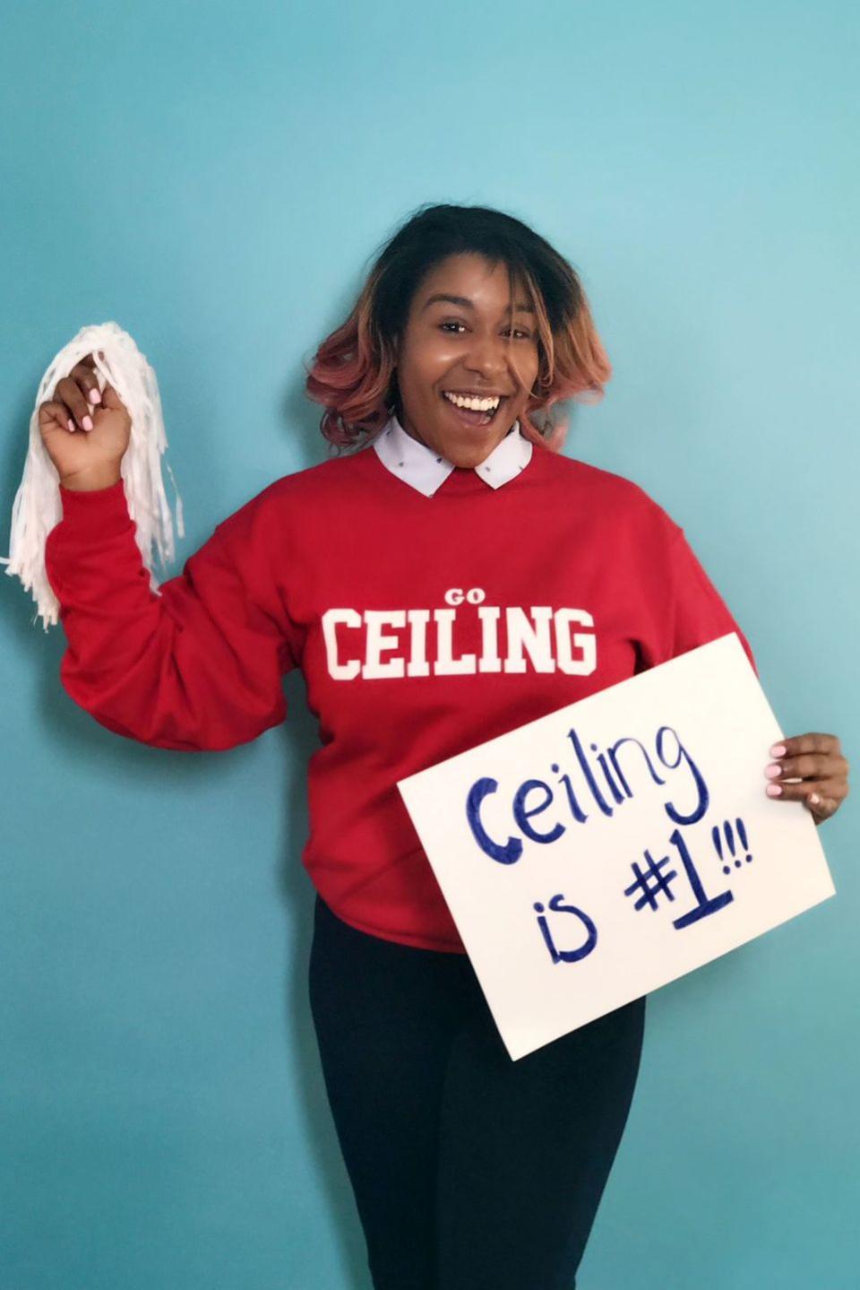 <p>Another pun costume that'll steal the show: Add some school — er, ceiling — cheer with this sweatshirt and poster combo. Don't forget the pom poms! </p>