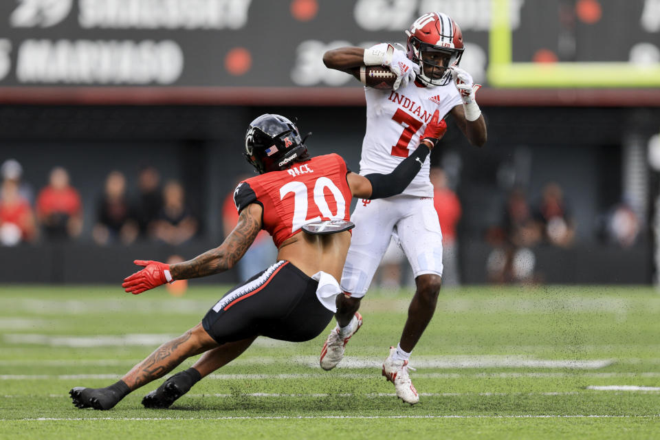 Indiana wide receiver D.J. Matthews Jr., (7) makes a catch and is tackled by Cincinnati wide receiver Jadon Thompson during the first half of an NCAA college football game, Saturday, Sept. 24, 2022, in Cincinnati. (AP Photo/Aaron Doster)