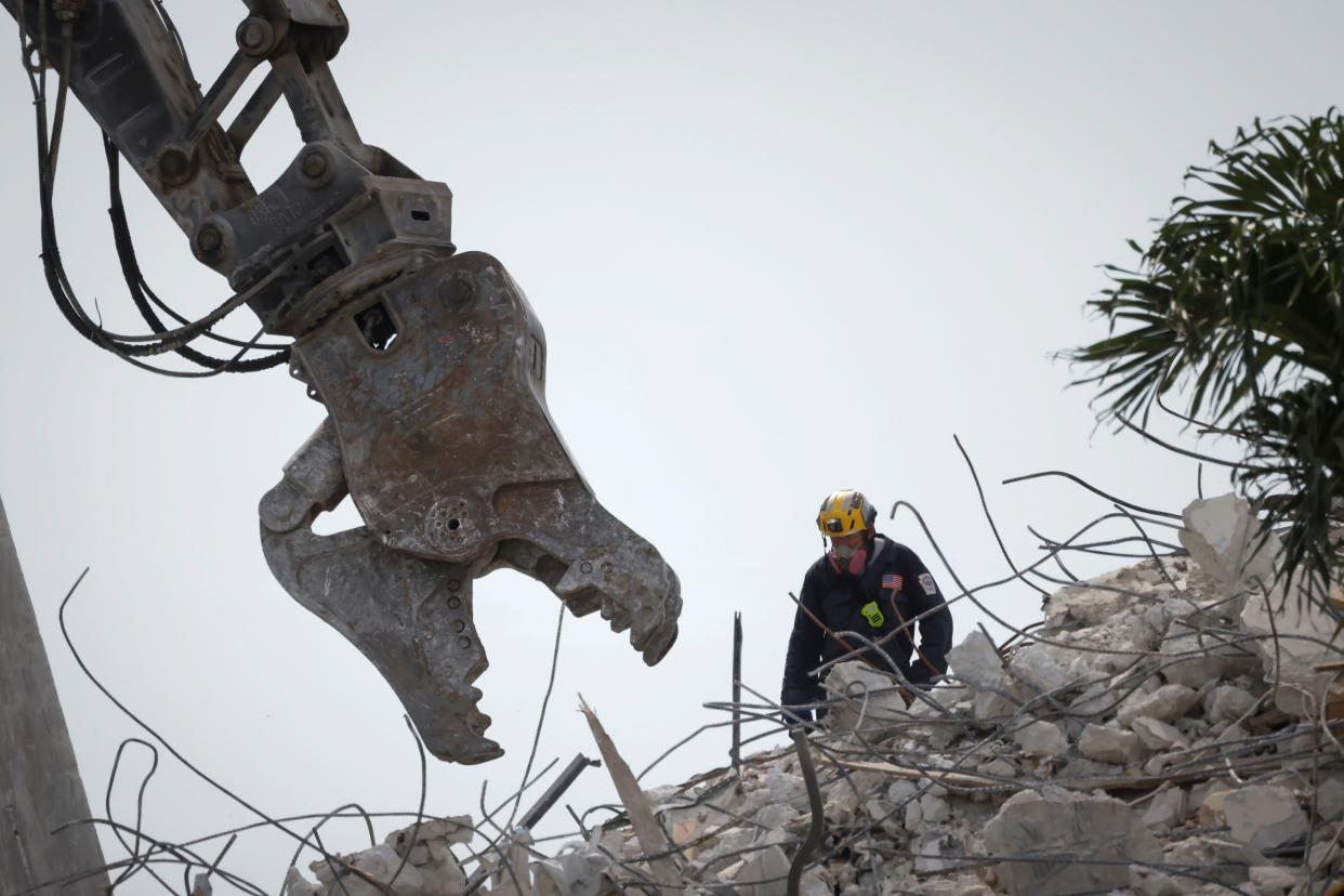 A rescue worker is seen on the pile of the collapsed buidling in Surfside, Fla,, Monday. (Marco Bello/Reuters)