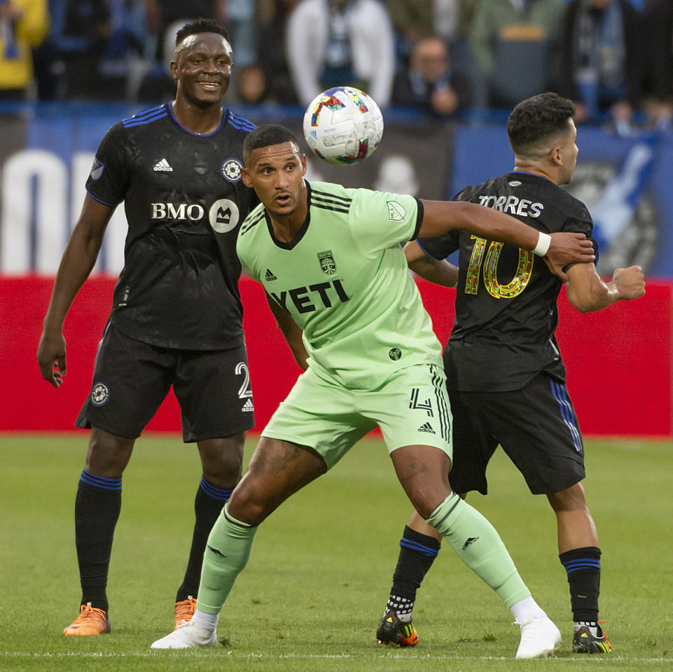 Austin FC defender Ruben Gabrielsen (4) shields the ball as CF Montréal midfielder Victor Wanyama (2) and midfielder Joaquín Torres (10) defend during first-half MLS soccer match action in Montreal, Saturday, June 18, 2022. (Peter McCabe/The Canadian Press via AP)