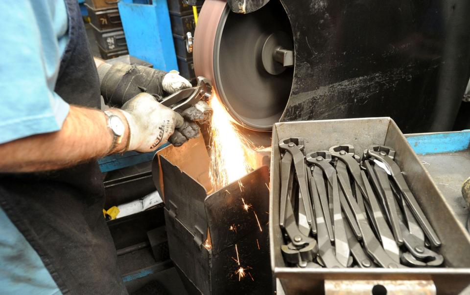 A Channellock Inc. employee polishes end nippers in this 2011 photo.