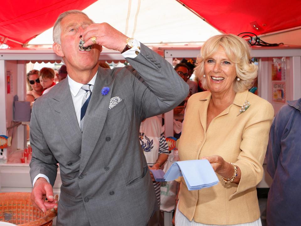 king charles eats an oyster next to camilla at the whitstable oyster festival in 2013