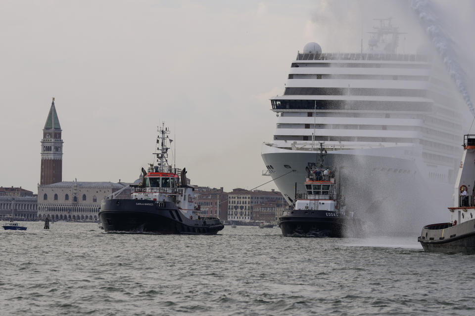 The the 92,409-ton,16-deck MSC Orchestra cruise ship exits the lagoon as St. Mark's Square stands out in background, left, as it leaves Venice, Italy, Saturday, June 5, 2021. The first cruise ship leaving Venice since the pandemic is set to depart Saturday amid protests by activists demanding that the enormous ships be permanently rerouted out the fragile lagoon, especially Giudecca Canal through the city's historic center, due to environmental and safety risks. (AP Photo/Antonio Calanni)
