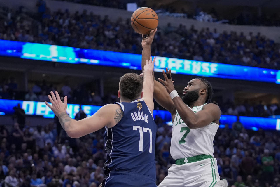 Boston Celtics guard Jaylen Brown, right, shoots against Dallas Mavericks guard Luka Doncic during the second half in Game 3 of the NBA basketball finals, Wednesday, June 12, 2024, in Dallas. (AP Photo/Tony Gutierrez)