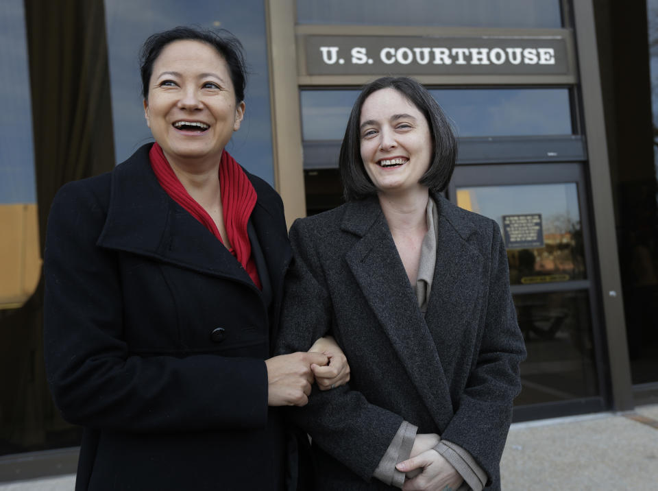 File - In this Feb. 12, 2014 file photo, Cleopatra De Leon, left, and partner, Nicole Dimetman, right, arrive at the U.S. Federal Courthouse, in San Antonio, where a federal judge is expected to hear arguments in a lawsuit challenging Texas' ban on same-sex marriage. On Wednesday, Feb. 26, 2014, Judge Orlando Garcia has struck down the ban but is leaving it in place pending a ruling by an appeals court later this year. (AP Photo/Eric Gay, File)