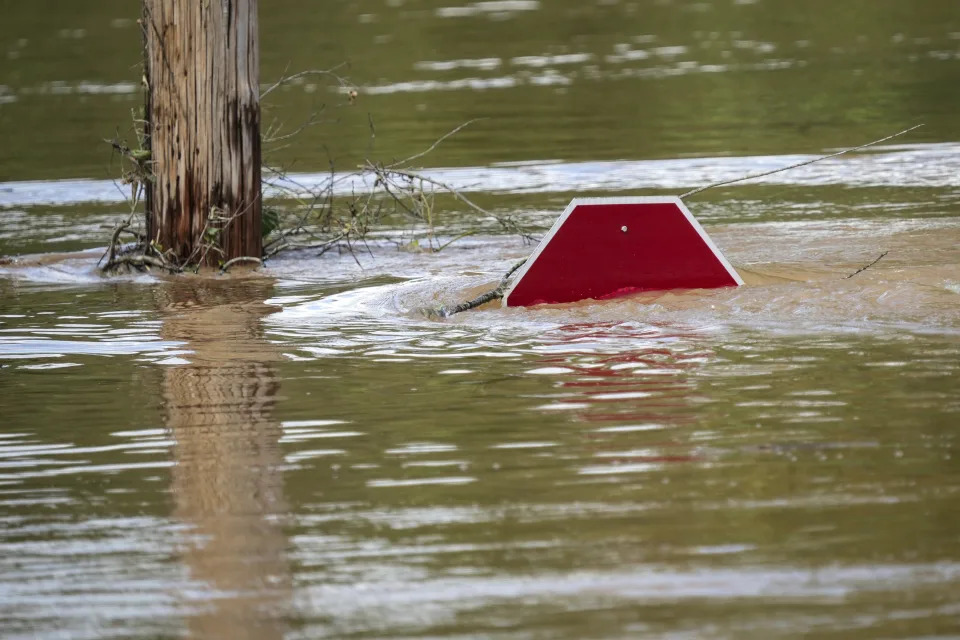 A stop sign can be barely seen above a flooded parking lot after torrential rain from Hurricane Helene caused severe flooding in Morganton, N.C., on Saturday.A stop sign can be barely seen above a flooded parking lot after torrential rain from Hurricane Helene caused severe flooding, Saturday, Sept. 28, 2024, in Morganton, N.C. (AP Photo/Kathy Kmonicek)