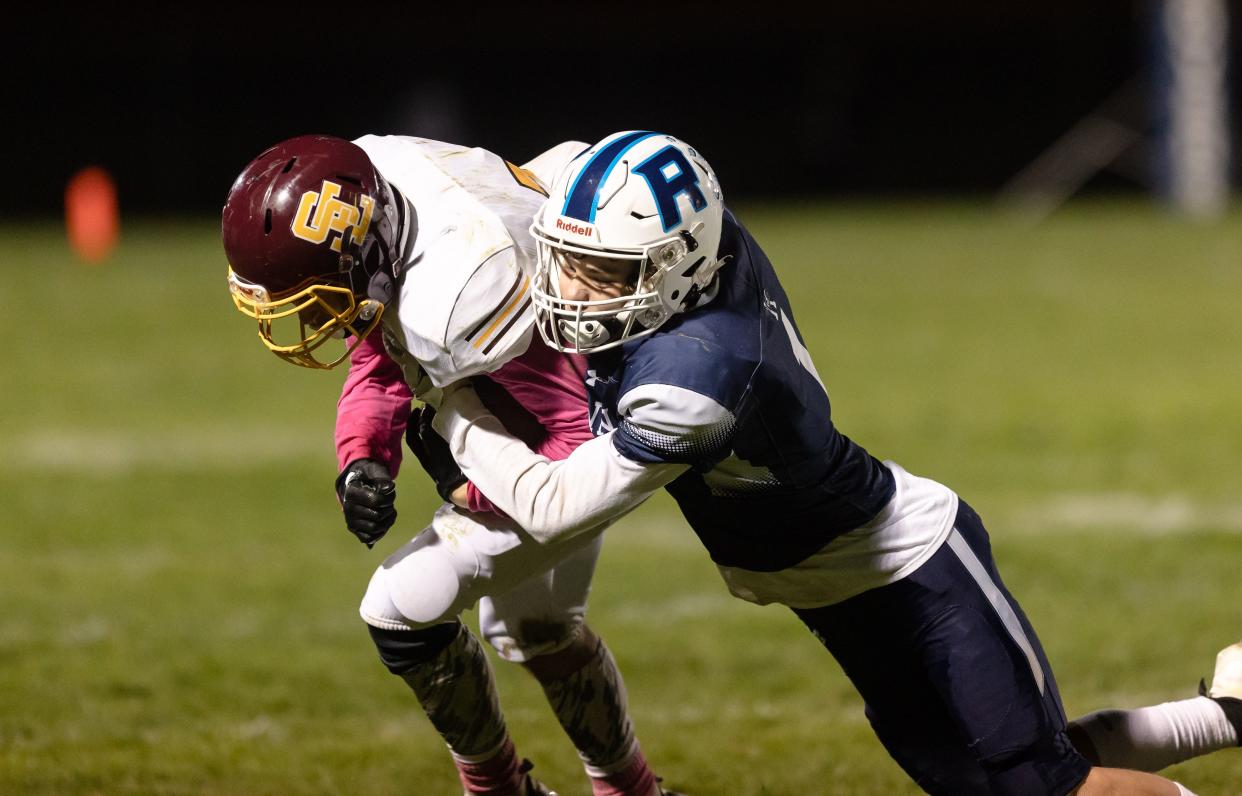 Rootstown senior Branden Bobbs tackles Southeast junior Case Myers on a passing play during Friday night's game at Rootstown High School.