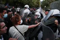 <p>Demonstrators scuffle with riot police, during a protest following the death of Mahsa Amini, outside the Iranian Embassy, in Athens, Greece, September 22, 2022. REUTERS/Costas Baltas</p> 