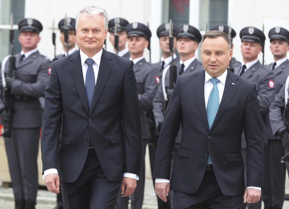 CAPTION CORRECTS THE NAME - Polish President Andrzej Duda, right, and Lithuanian President Gitanas Nauseda, left, attend a military welcome ceremony at the presidential Palace in Warsaw, Poland, Tuesday, July 16, 2019.(AP Photo/Czarek Sokolowski)