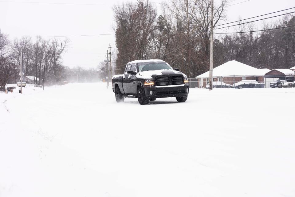 A truck drives on a snow covered street in the Raleigh area on Dr. Martin Luther King Day on Monday, Jan. 15, 2024. The Memphis area is expecting 3 to 6 inches of snow and below-freezing temperatures.