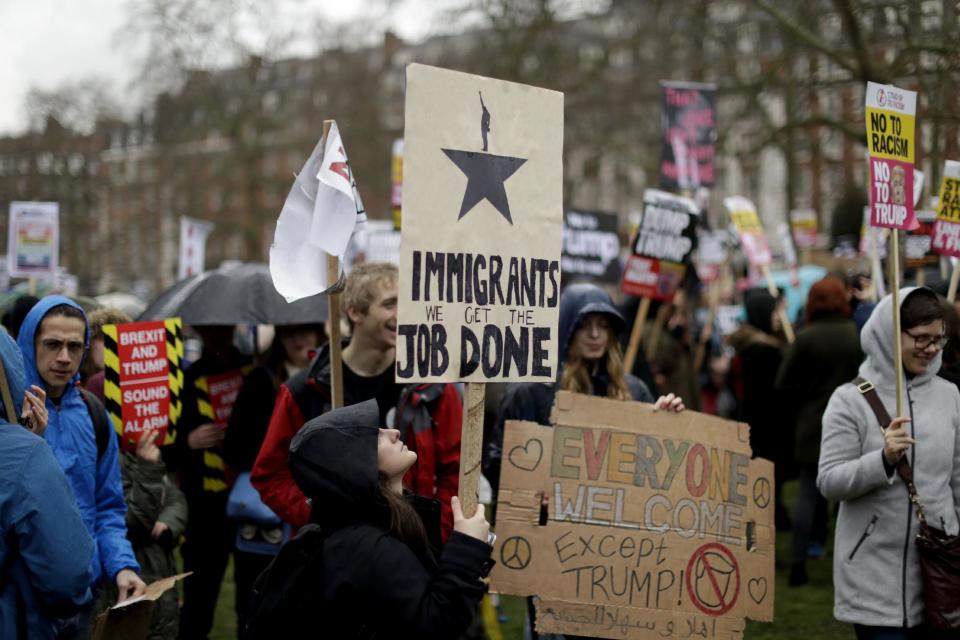 A demonstrator holds a placard as she takes part in a protest outside the U.S. embassy in London, against U.S. President Donald Trump's ban on travellers and immigrants from seven predominantly Muslim countries entering the U.S., Saturday, Feb. 4, 2017. (AP Photo/Matt Dunham)