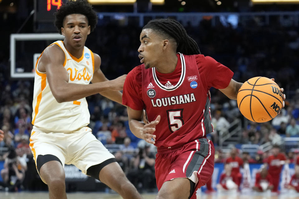 Louisiana guard Jalen Dalcourt (5) drives past Tennessee forward Julian Phillips, left, during the first half of a first-round college basketball game in the NCAA Tournament Thursday, March 16, 2023, in Orlando, Fla. (AP Photo/Chris O'Meara)