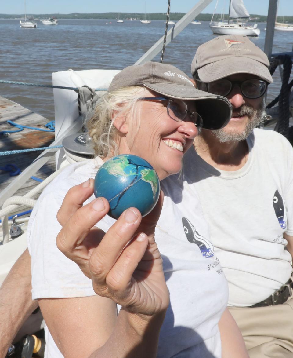 Robin Bell and Karl Coplan on the Mabel Rose at the Nyack Boat Club May 7, 2024. They had just returned from sailing the boat around the world. They kept track of their route by marking it a ball globe.