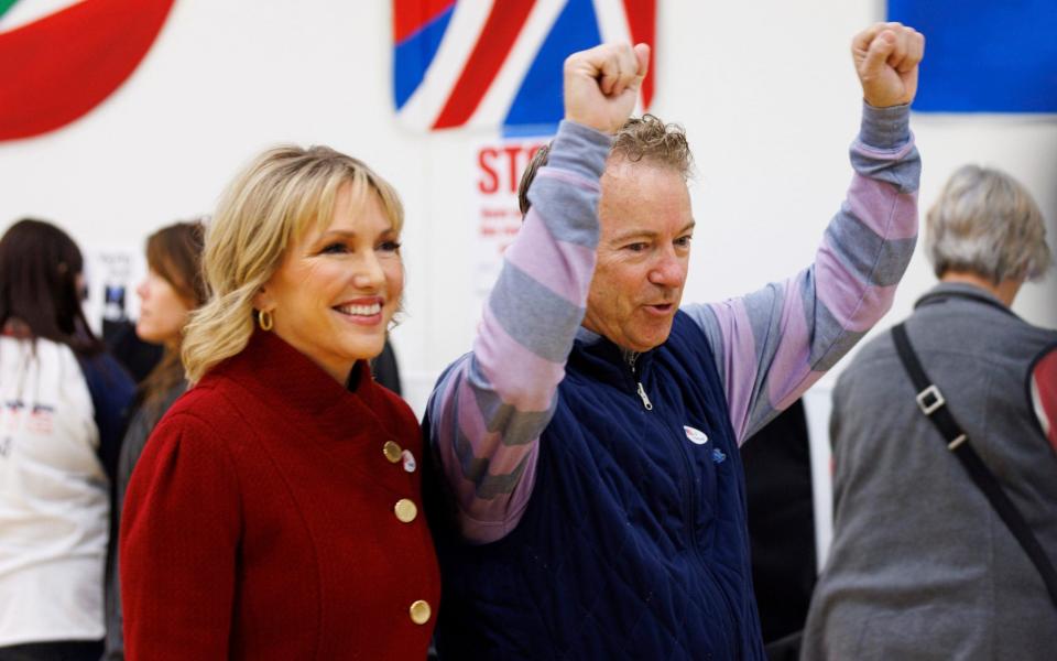 Sen. Rand Paul raises his arms up after casting his vote with his wife Kelley at Cumberland Trace Elementary School in Bowling Green, Kentucky - AP Photo/Michael Clubb