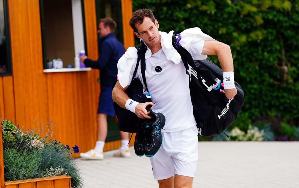 Andy Murray drags in his racquet bag