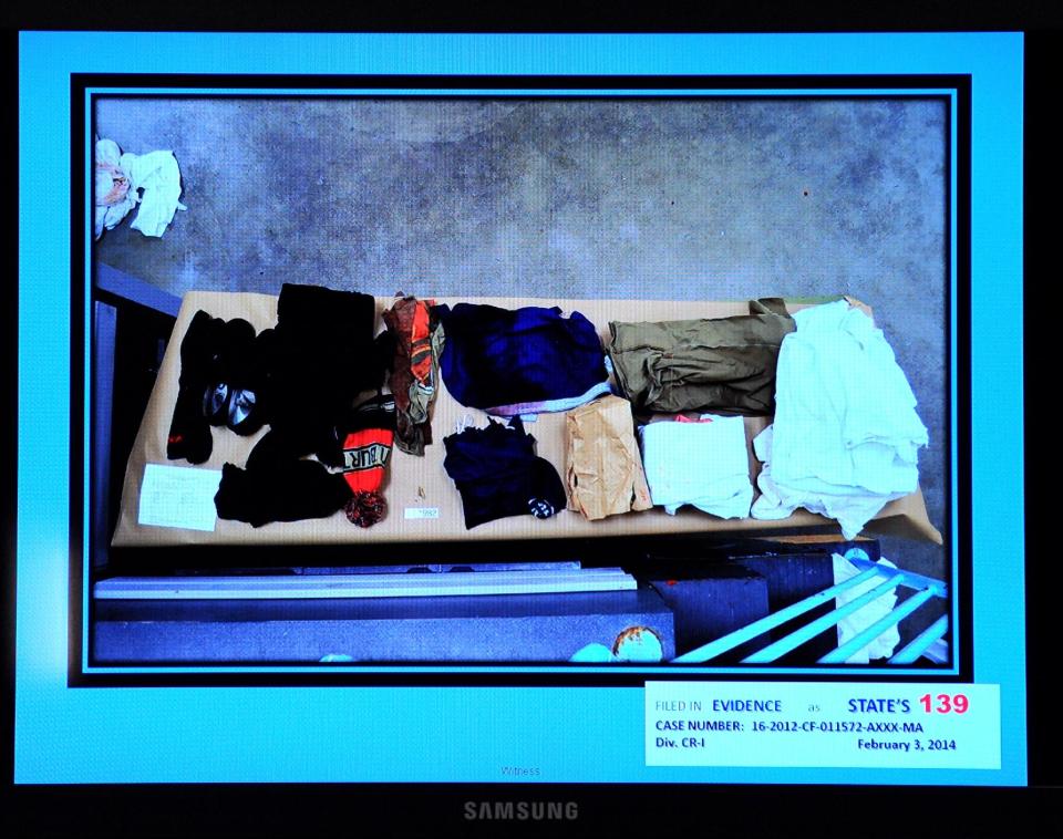 The prosecution in the Michael Dunn trial shows the clothing worn by Jordan Davis on the night he was shot during testimony in Jacksonville, Fla. , Monday, Feb. 10, 2014. The prosecution has rested in the trial of a Michael Dunn charged with killing Davis following an argument over loud music outside a Jacksonville convenience store in 2012. (The Florida Times-Union, Bob Mack, Pool)