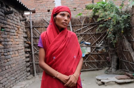 Sahana, mother of Soni Khatun, who died of acute encephalitis syndrome or brain fever, stands inside her home in Khurd village