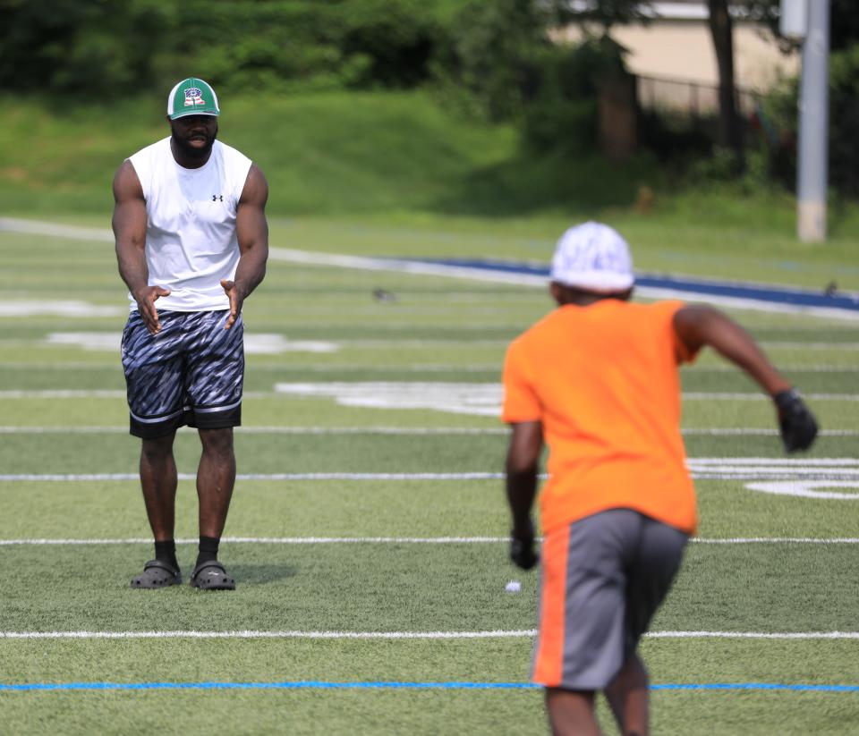 Shonda Faulkner gives instructions to a player during Roy's Community Foundation youth football camp in the City of Poughkeepsie on August 3, 2023. 