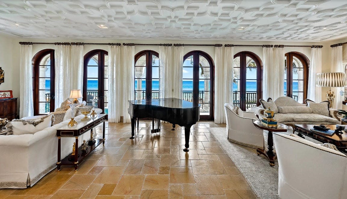 French doors in the living room of a duplex condominium at 102 Gulfstream Road open to a veranda facing the Atlantic and Midtown Beach. Priced at $21 million, the residence is the most expensive condo in the Palm Beach Board of Realtors Multiple Listing Service.