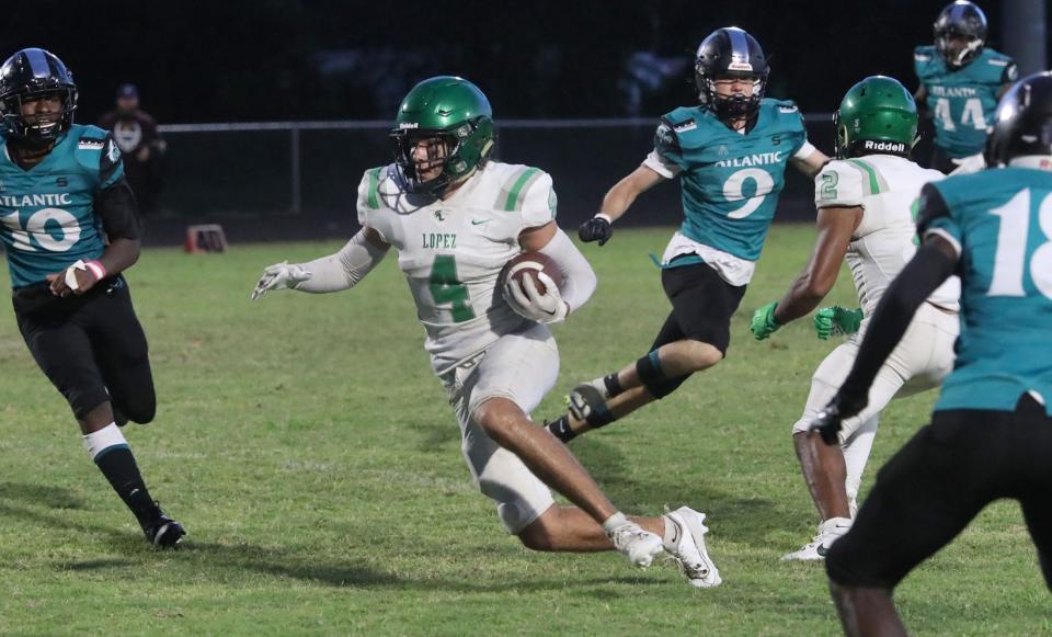 Father Lopez's Lech Sweeney (4) looks for space after making a catch against Atlantic, Monday, Sept. 11, 2023.