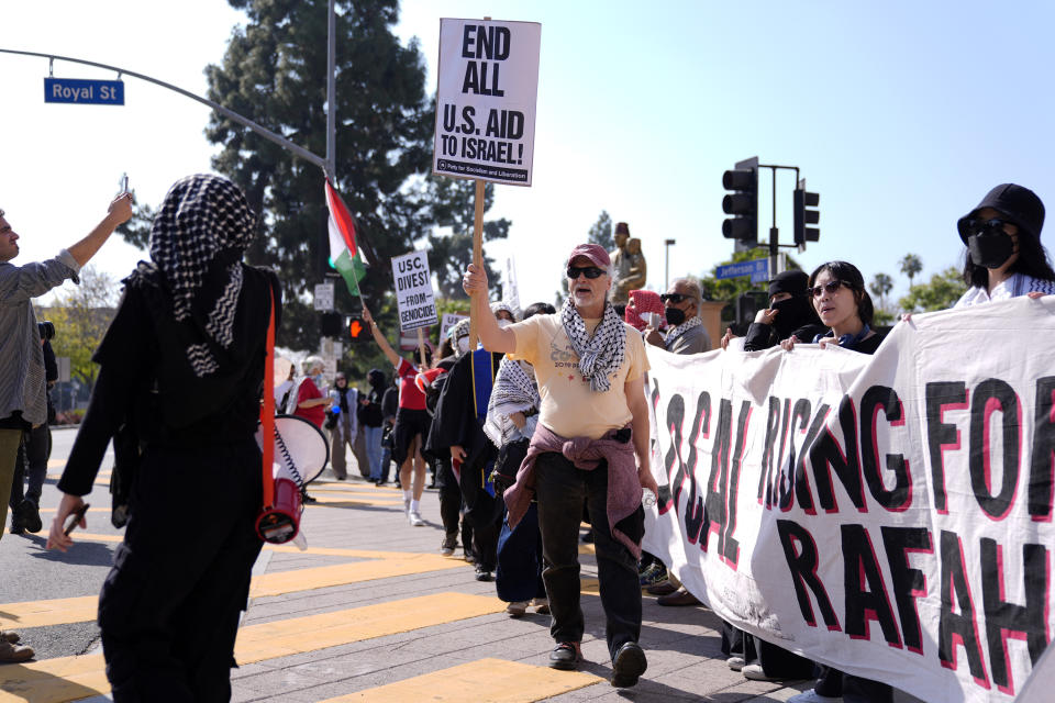 Pro-Palestinian demonstrators are seen at the Shrine Auditorium where a commencement ceremony for graduates from Pomona College was being held, Sunday, May 12, 2024, in Los Angeles. (AP Photo/Ryan Sun)