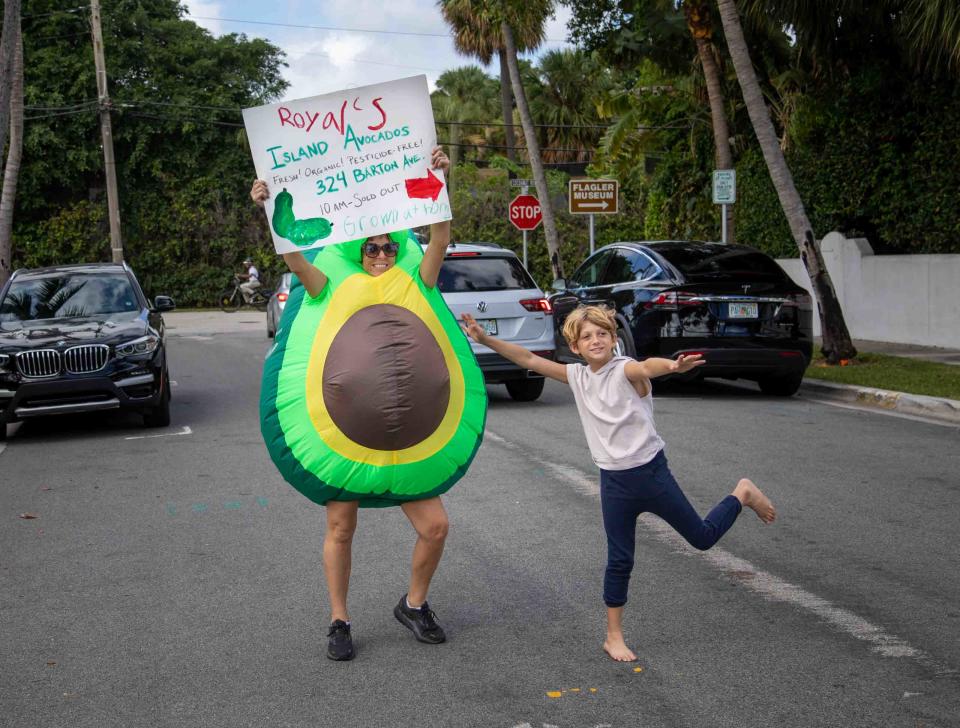 Royal Douglass and his aunt Penelope Miller, have fun trying to get drivers to stop by Royal's Island Avocado sale on Oct. 29.