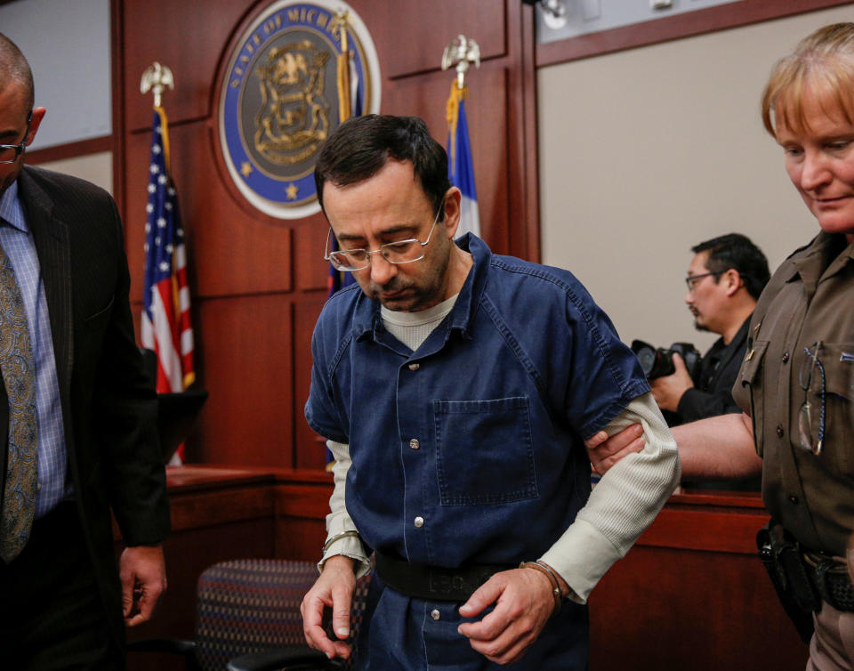 Larry Nassar, a former team USA Gymnastics doctor who pleaded guilty in November 2017 to seven counts of sexual assault, is escorted by a court officer during his sentencing hearing. (Reuters)