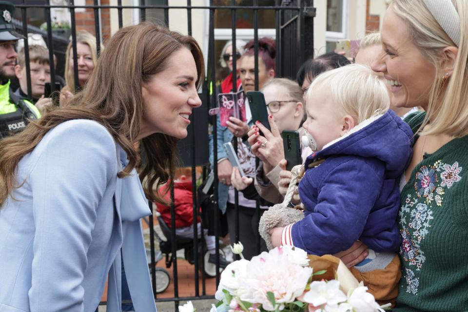 Catherine, Princess of Wales speaks with a young well-wisher after her visit to the PIPS (Public Initiative for Prevention of Suicide and Self Harm) charity with Prince William, Prince of Wales on October 06, 2022 in Belfast, Northern Ireland