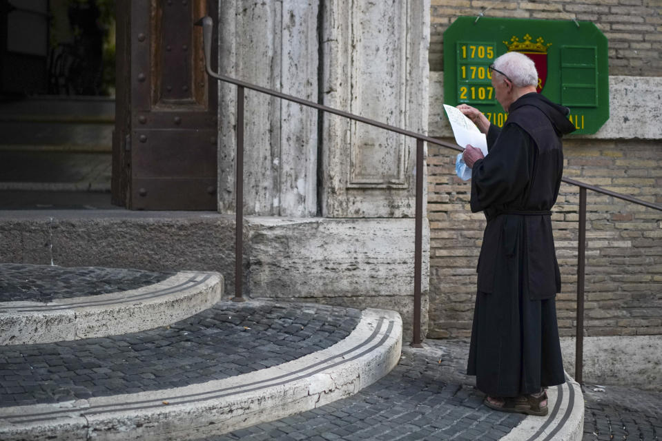 A friar arrives at a polling station, in Rome, Sunday, Sept. 20, 2020. On Sunday and Monday Italians are called to vote nationwide in a referendum to confirm a historical change to the country's constitution to drastically reduce the number of Members of Parliament from 945 to 600. Eighteen million of Italian citizens will also vote on Sunday and Monday to renew local governors in seven regions, along with mayors in approximately 1,000 cities. (AP Photo/Andrew Medichini)