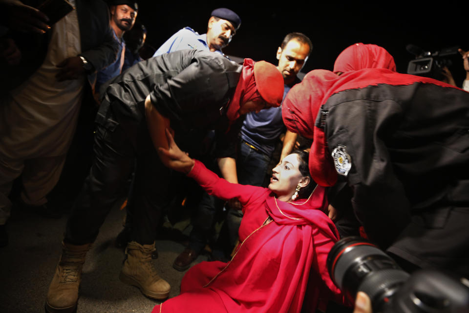 Police officers detain a supporter of Pakistan's Prime Minister Imran Khan outside the National Assembly after no-confidence vote, in Islamabad, Pakistan, Sunday, April 10, 2022. Pakistan's political opposition ousted the country's embattled prime minister in a no confidence vote on Saturday, which they won after several of Imran Khan's allies and a key coalition party deserted him. (AP Photo/Anjum Naveed)