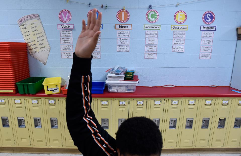 A third grader students raises his hand during class as he works on an English language arts assignment at Dodson Elementary School on June 6. The class was part of Promising Schools, the summer program offered by Metro Nashville Public Schools.