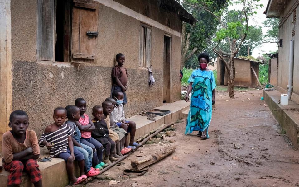 Farmer Margaret Nakanyike, one of those herded into the isolation unit after two members of her household showed Ebola signs and says she was lucky to escape infection, walks near her house in Madudu, the subcounty that's been hardest hit by the new Ebola outbreak, near Mubende, in Uganda - Hajarah Nalwadda/AP