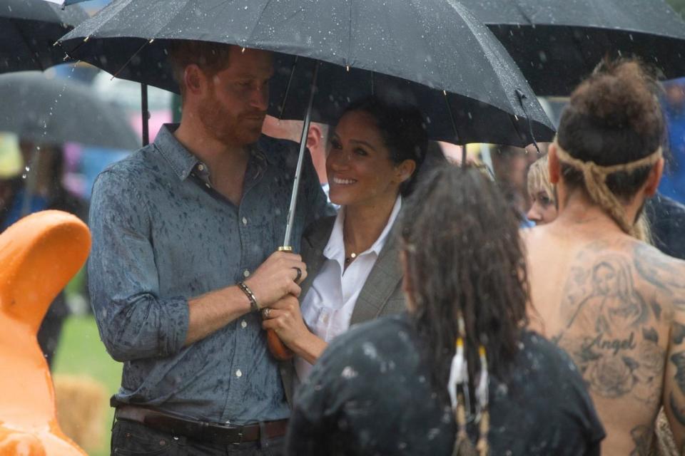 Meghan, 37, held a brolly over her husband Harry’s head as he addressed the crowds (PA)