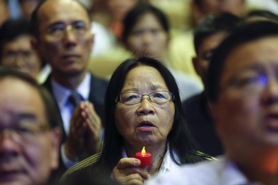 People take part in a special prayer for passengers onboard the missing Malaysia Airlines flight MH370 at the MCA headquarters in Kuala Lumpur