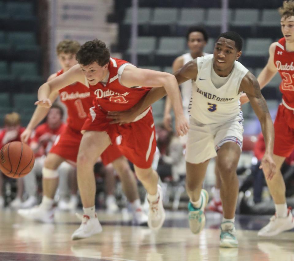 Jack Maloney of Tappan Zee tries to grab the loose ball while being pursued by Xavier Gissendanner of Irondequoit during the NYSPHSAA Class A basketball championship at the Cool Insuring Arena in Glens Falls. Tappan Zee defeated Irondequoit 49-36.